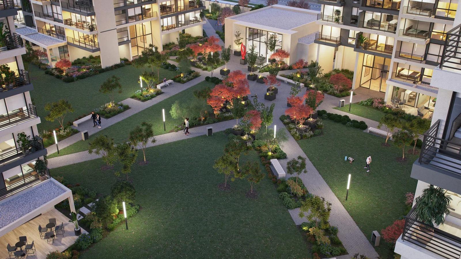 Vista aérea nocturna de parque interior iluminado entre condominios - Metropolitan Park, Inmobiliaria Imagina